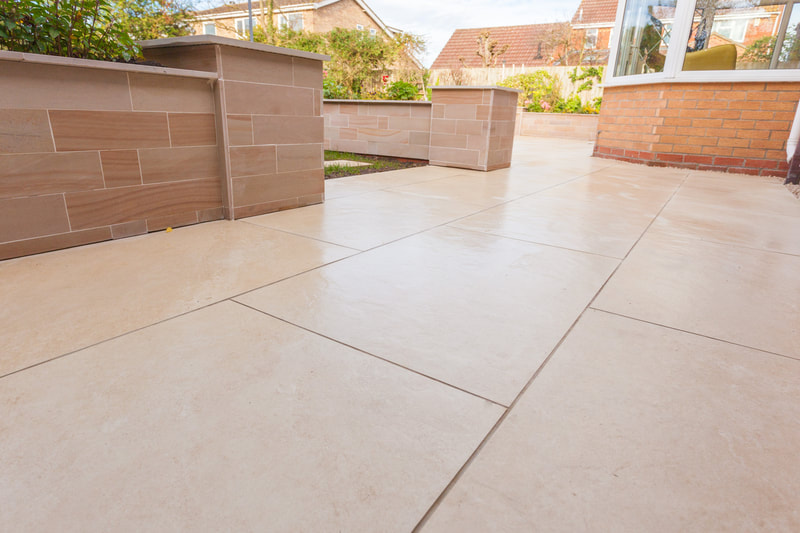 Green Room Gardens - porcelain paving with sleeper raised bed wall