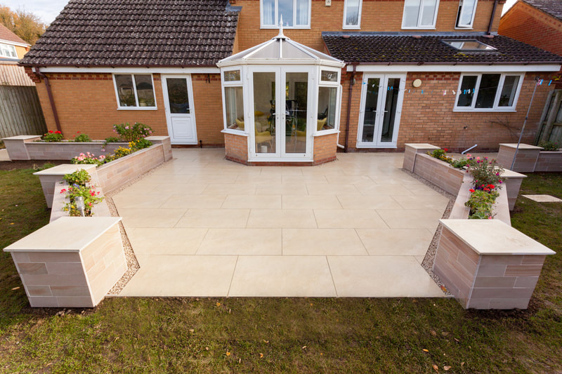 Green Room Gardens - garden view with conservatory, paving and lawn