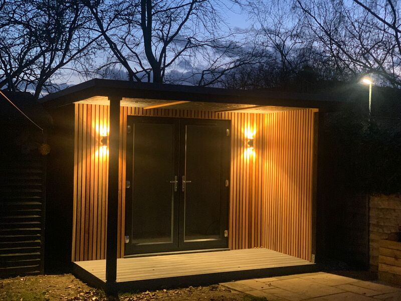 Green Room Gardens - garden room at night with bi-fold doors and lit interior